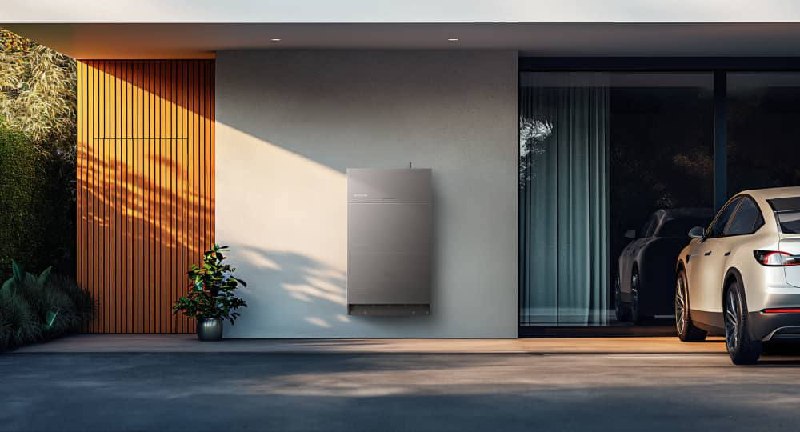 EcoFlow home battery installed on a modern house wall beside a driveway