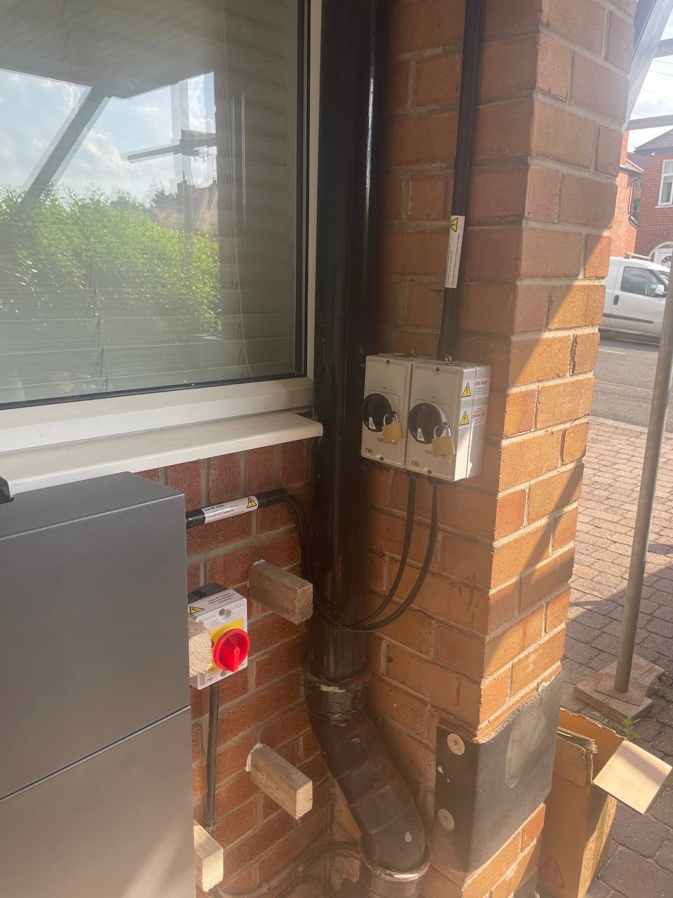 Electrical isolators and battery wiring installed on external brickwork