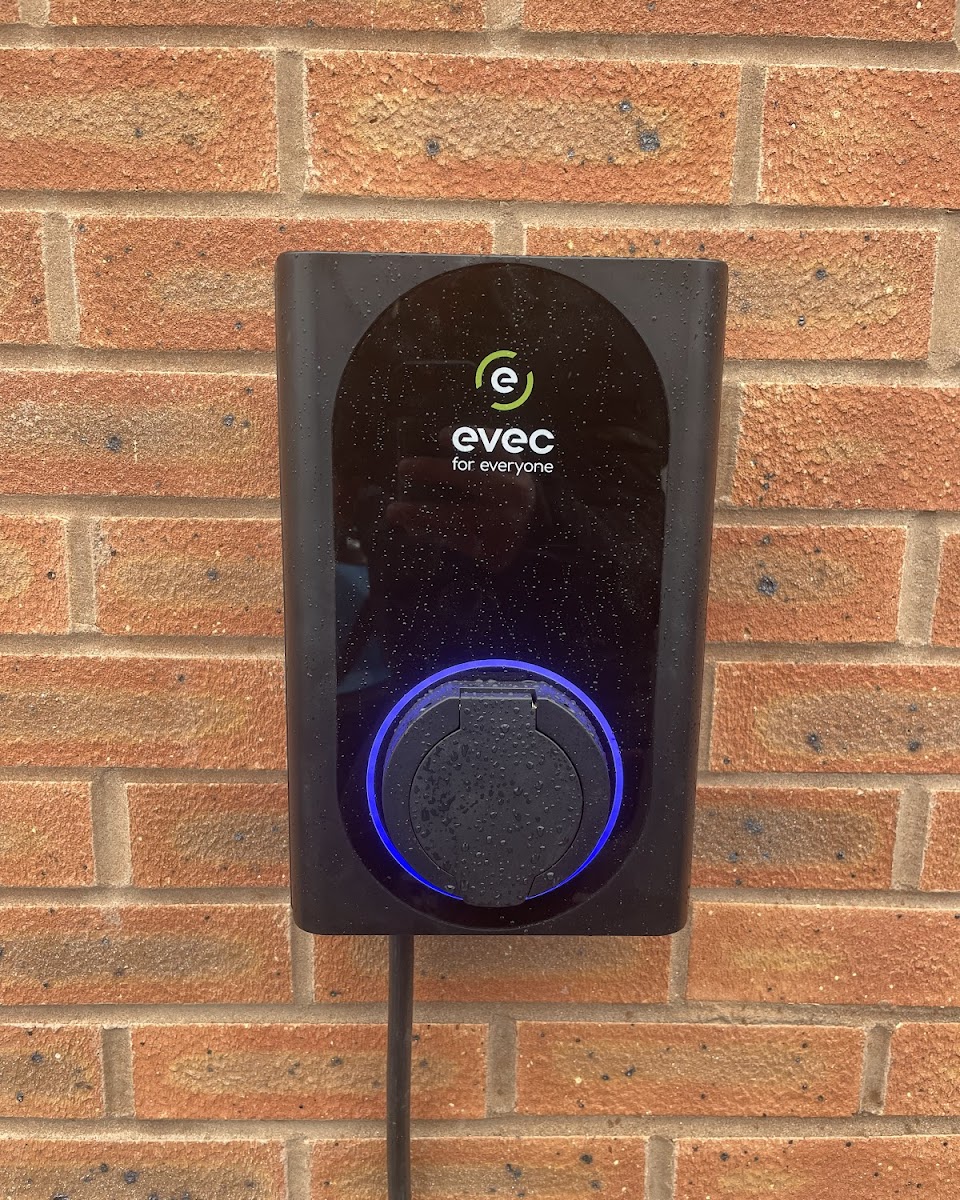 Evec EV charger installed on a brick wall