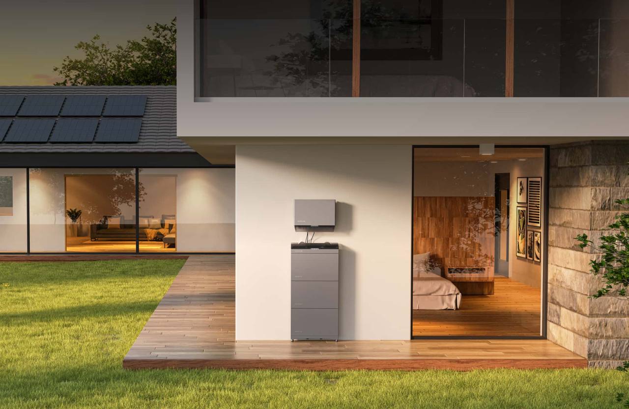 Home battery storage system installed outside a modern house